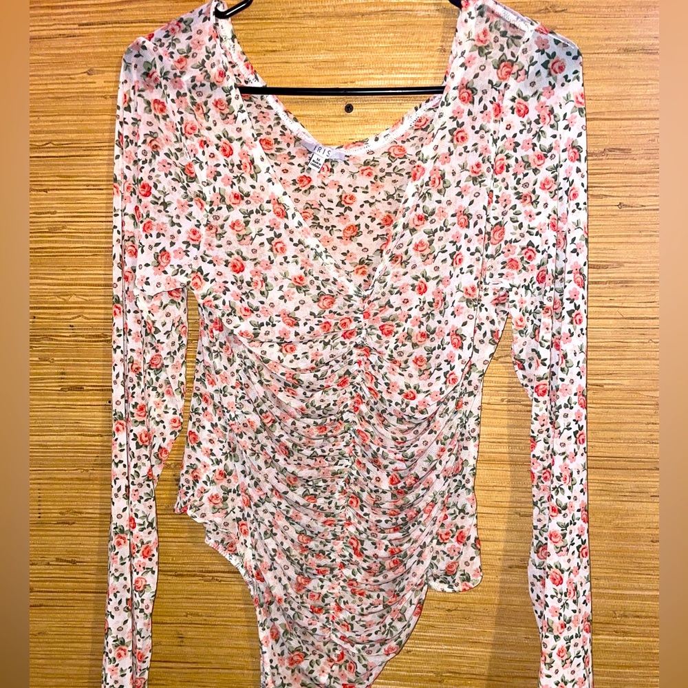 Woman’s white see-through body suit with roses